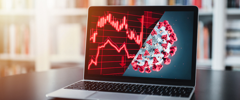 A laptop monitor divided in half, one side displaying charts and the other showing a virus.