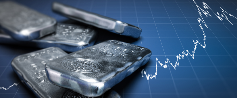 Silver bars accompanied by candlestick charts, capturing the dynamic nature of market trends in the precious metals sector.