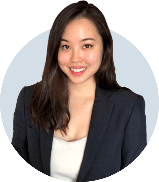 Experienced prop trader Cassandra Ng smiling in a blue jacket and white top