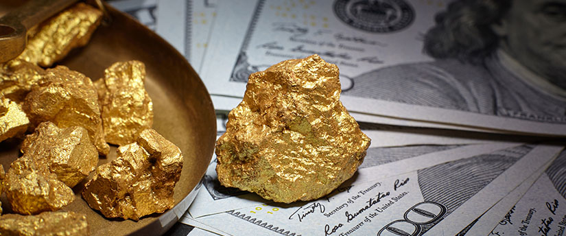 Some pieces of gold on some US dollars depicting online metal trading