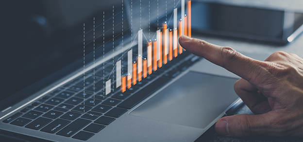 A trader in front of a laptop intently observing a chart, capturing the essence of a dedicated forex trader.