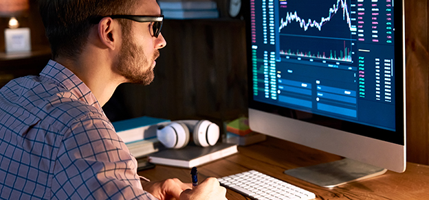 a man is looking at a screen which shows prices and different charts which relate to how to buy stocks.