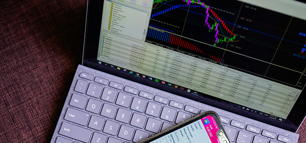 An array of electronic devices, including computers, smartphones, and tablets, collectively displaying the renowned MetaTrader 4 trading platform.