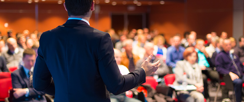 A seasoned pro trader imparting wisdom and knowledge to eager learners during informative and educational forex seminars.