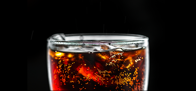 An icy cold glass of Coca-Cola, epitomizing the refreshing and beloved soft drink.