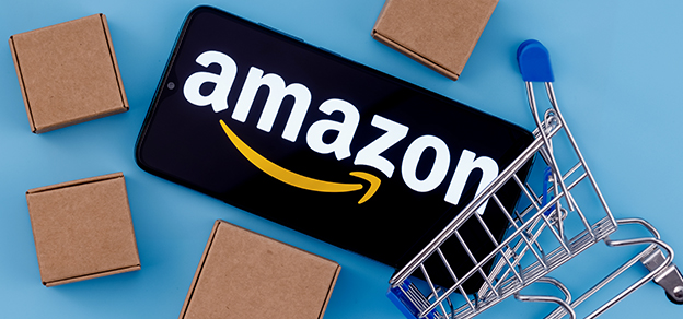 A mobile device with the Amazon logo displayed, surrounded by boxes, embodies the convenience and accessibility of Amazon's services. 