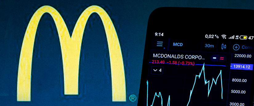 A mobile device displaying forex data with the McDonald's logo, illustrating the intersection of finance and fast food.