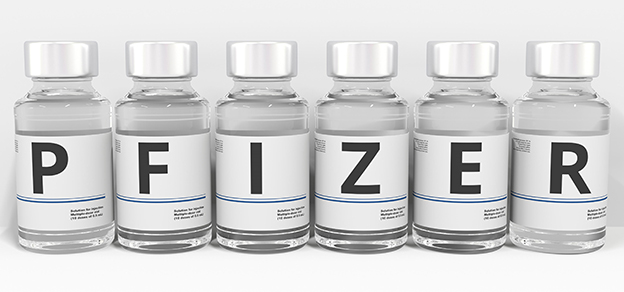 Small vials of Pfizer vaccine medicine, symbolizing the battle against disease and the importance of vaccination.