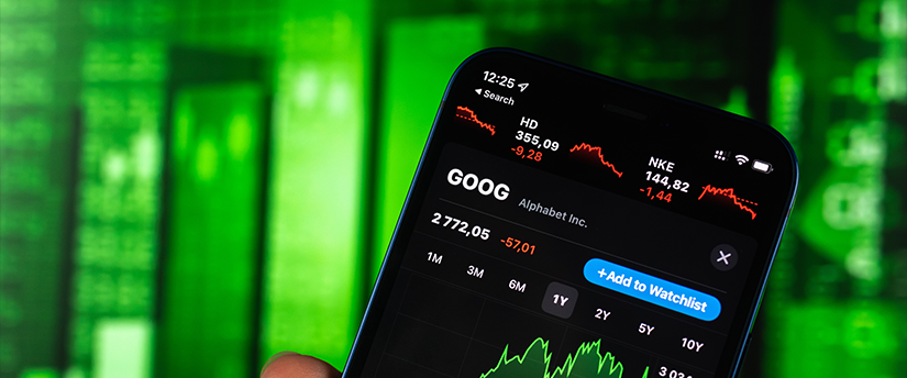 The alphabet with a trader holding a mobile device displaying forex data, highlighting the connection of language and finance.