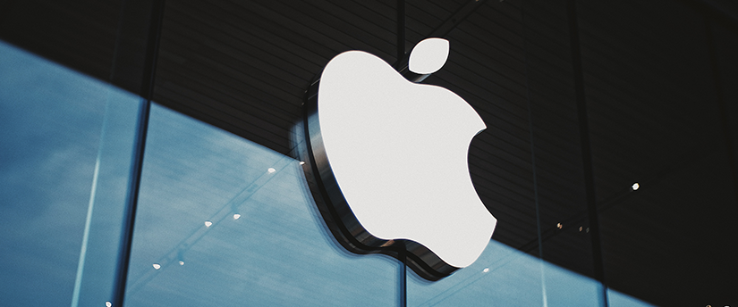 A modern urban landscape with a prominent Apple logo adorning a sleek building, symbolizing the tech giant's presence in the cityscape