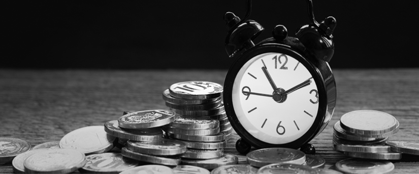A clock surrounded by coins, representing long-term investing.