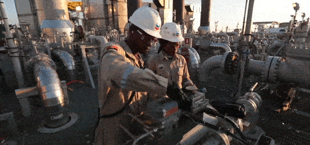 Two workers engaged in tasks at Chevron, the oil company, symbolizing diligence and collaboration in the energy sector.