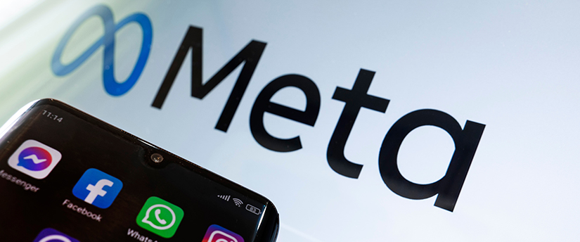 A mobile phone displaying the Meta logo with a background of futuristic technology concepts.