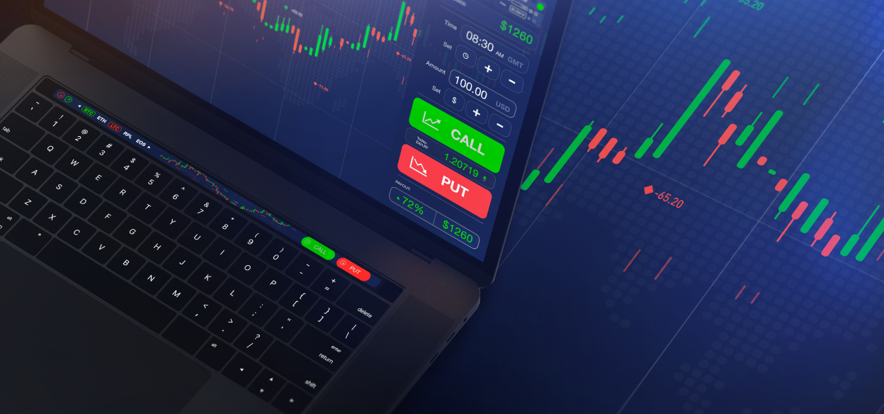 A laptop displaying MetaTrader 4 with candlestick charts in the background for technical analysis.