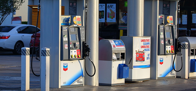Chevron gas station with a row of bright green gas pumps, ready to fuel up your car with quality Chevron gasoline.