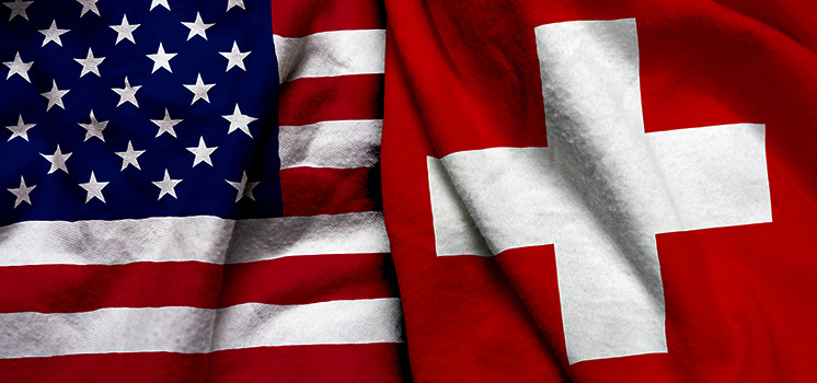 The US and Swiss flags side by side, representing the USD/CHF currency pair, where these two economic giants meet in the world of finance.