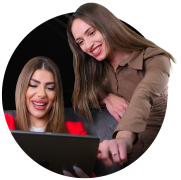 Two brokers looking at a tablet's screen.