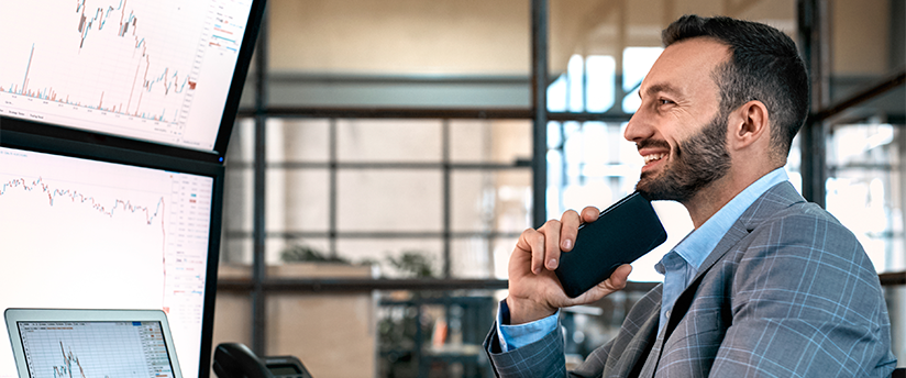 A jubilant trader joyfully monitoring screens, appreciating the services of the best forex broker.