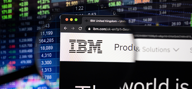 A board displaying data alongside a web browser featuring the IBM logo, illustrating the integration of information technology.