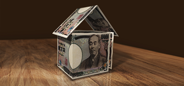 Yen symbols creatively intertwining to construct a symbolic house, representing financial stability and the housing market.
