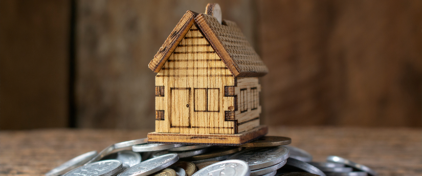 Yen symbols creatively intertwining to construct a symbolic house, representing financial stability and the housing market.