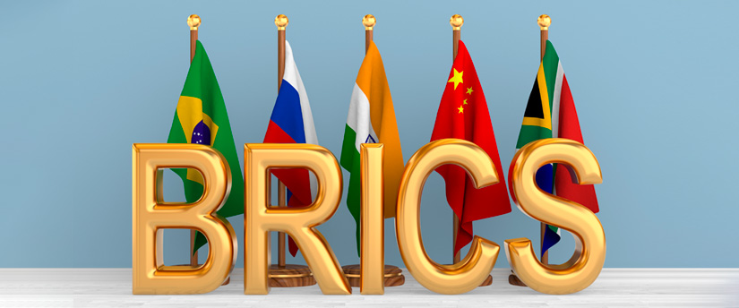 Flags of Brazil, Russia, India, China, and South Africa united in front, symbolizing the BRICS partnership