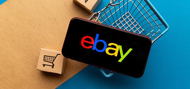 A mobile with the eBay logo placed atop a basket, combining e-commerce with a unique presentation.