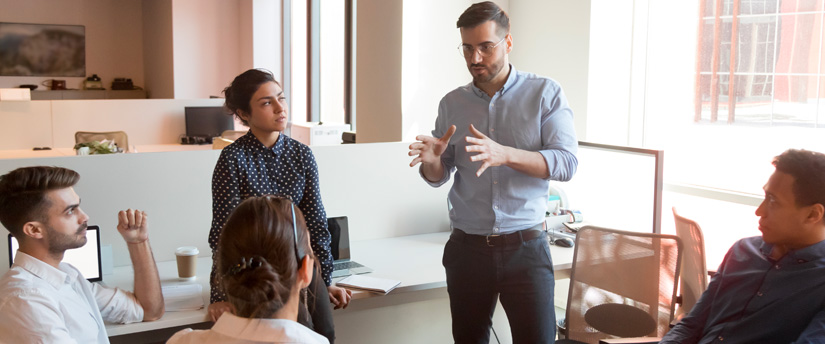 A man addressing a group signifies the educational and informative role of forex brokers in guiding traders through the market.