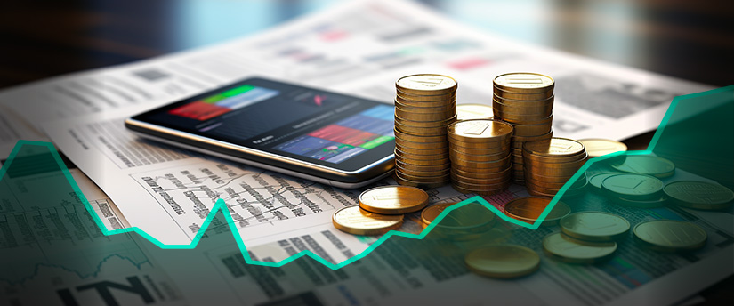 A mobile device displaying CFD data with gold coins positioned nearby, illustrating the connection between CFD trading and precious metals.