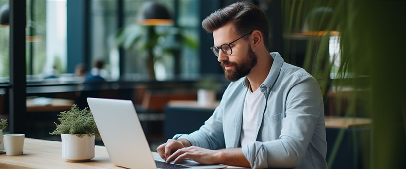 A focused trader intently analyzing data on a laptop, actively participating in the dynamic world of CFD trading.