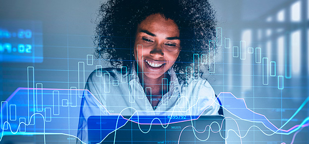 A trader positioned in front of a laptop, actively engaged in the world of indices trading.