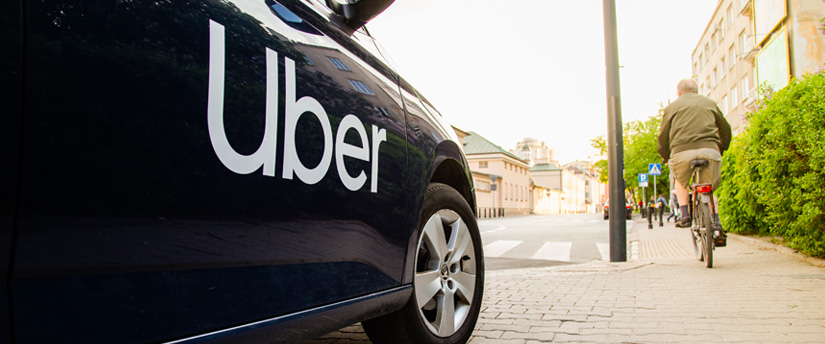 Cruising down the street, I spot a stylish car, unmistakably marked with the iconic UBER signage, ready to whisk passengers to their destinations.