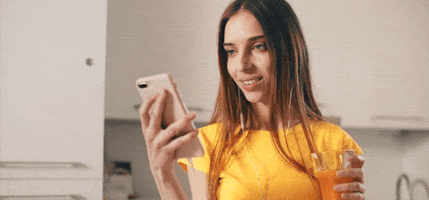 A person holding a mobile phone displaying the Snapchat app interface.