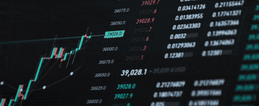 A trader uses a computer screen to analyze a candlestick chart and make informed CFD trading decisions.