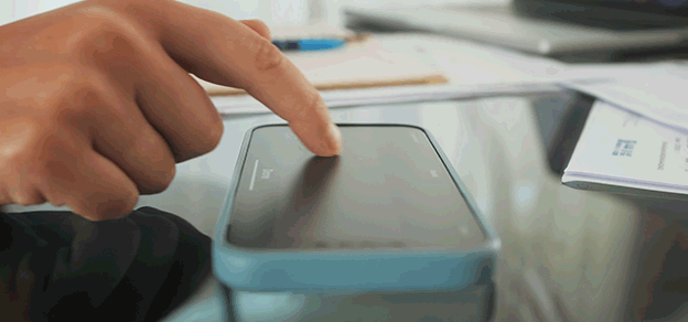 A hand signing a document on a mobile phone using DocuSign, showcasing the convenience of electronic signatures.