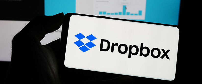Person holding a phone with the Dropbox logo on it