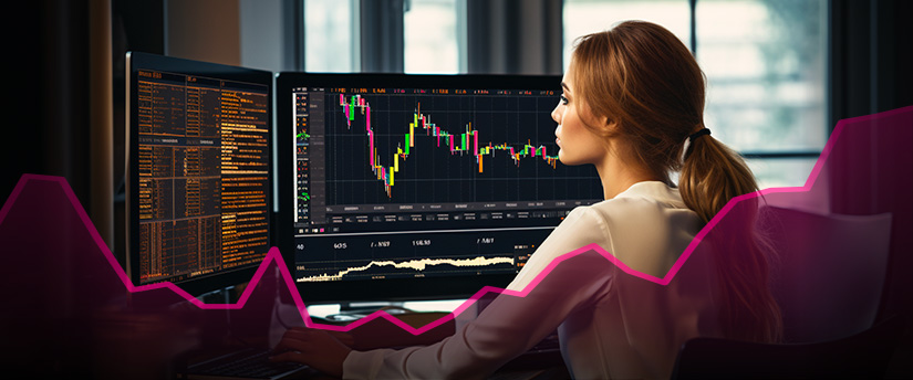 A successful CFD trader sitting in front of a computer monitor.