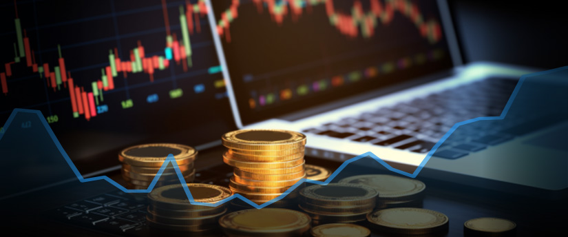 Trade CFDs with a stack of coins on a laptop keyboard.