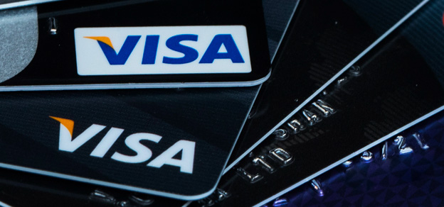 A stack of Visa cards, representing a common and widely accepted form of payment.