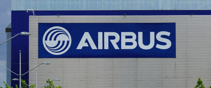The Airbus sign displayed prominently on a building, representing the company's presence and influence in the aerospace industry.