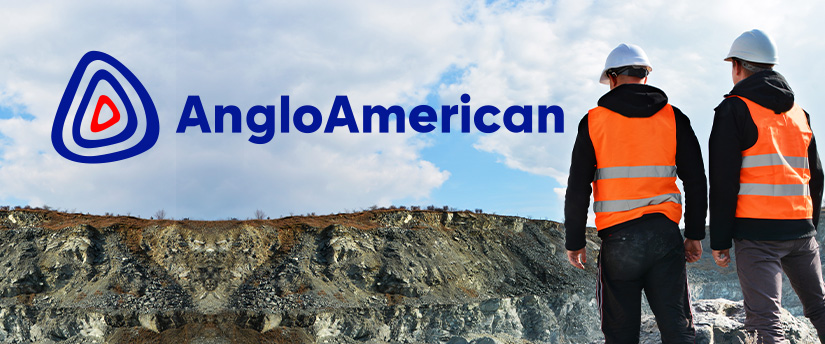 Two workers standing in front of a mountain, representing Anglo American's commitment to mining and resource exploration.