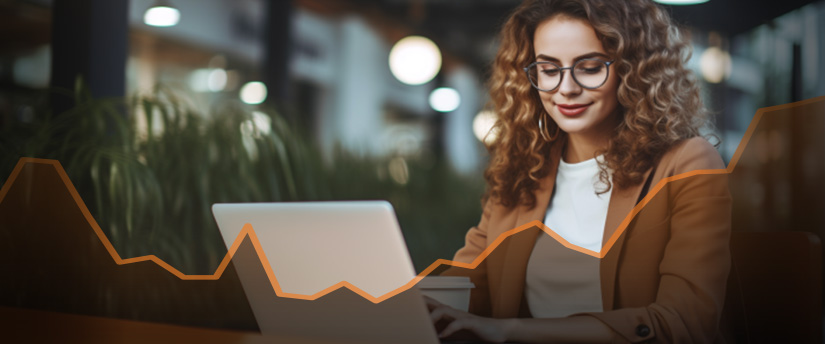 A trader woman wearing glasses intently studies a graph on her laptop, focusing on the data displayed how to be an expert in trading