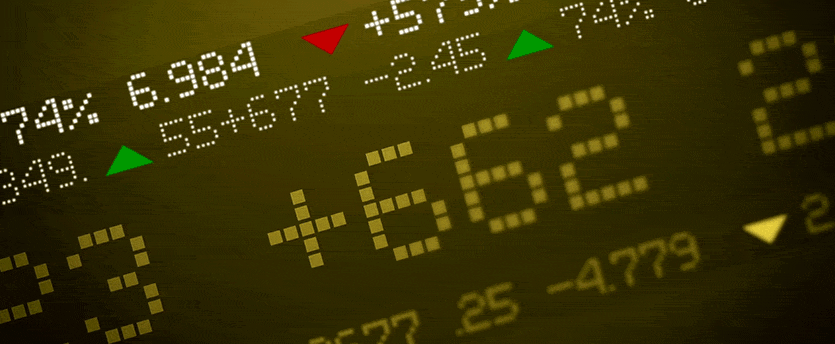Close-up of stock market display showing fluctuating numbers and graphs