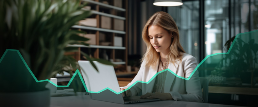 A woman engaged in forex trading, focused on her laptop screen displaying a graph chart