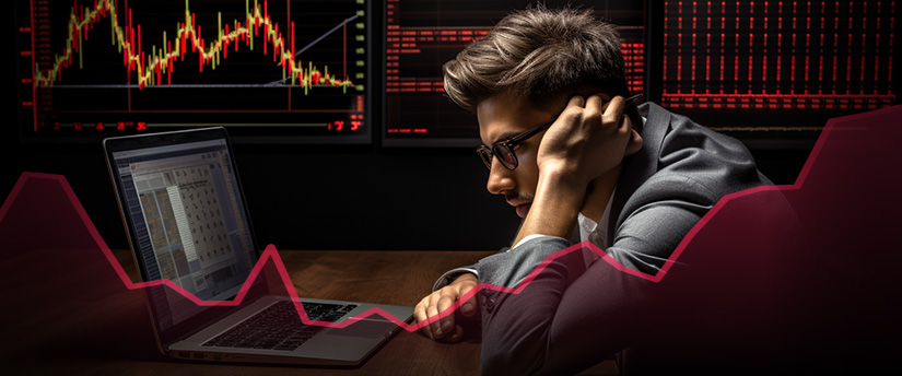 A professional man in a suit sits before a laptop displaying a graph, possibly engaged in forex trading or contemplating reasons to quit investing.