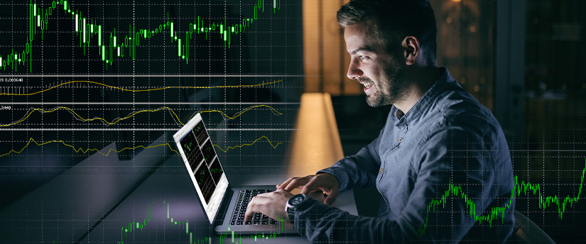 A man analyzing stock market graphs on a laptop using Metatrader 4 trading platform.