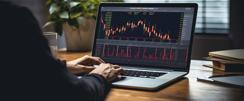 A laptop displaying forex market trading activity, showcasing financial data and charts.