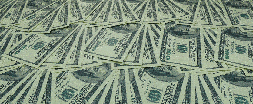 An image capturing a heap of money, specifically dollars, is presented in this photograph.