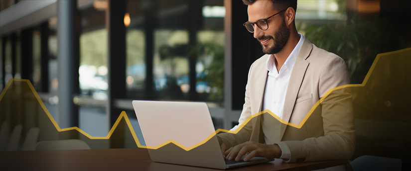 A professional man in a suit focused on his laptop, engrossed in work.