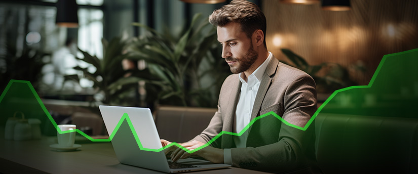 A man in a suit intently works on his laptop, possibly engaged in forex trading, embodying the image of a successful investor or aspiring millionaire.